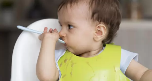 adorable-baby-playing-with-food-scaled