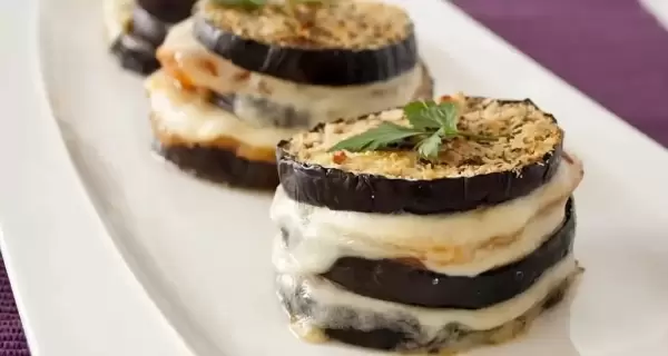 Milhojas de berenjena con queso mozzarella y tomate, un plato ligero y delicioso.