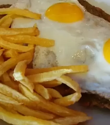 Milanesas a caballo con salsa, queso, jam�n y huevo, un plato cl�sico argentino.